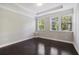 Bright bedroom featuring hardwood floors, tray ceiling, and natural light from large windows at 1829 Hislop Ln, Atlanta, GA 30345