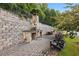 Stone outdoor patio area with custom stone fireplace and a sitting area at 1829 Hislop Ln, Atlanta, GA 30345
