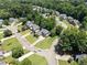 Aerial view of a neighborhood showcasing well-maintained homes, mature trees, and landscaped yards in a suburban setting at 3820 Ridge Point Dr, Suwanee, GA 30024