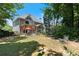 Large backyard has mature trees, a pergola covered table and outdoor seating at 3820 Ridge Point Dr, Suwanee, GA 30024