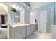 Bright bathroom boasts dual sinks, stylish tile floors and plenty of storage at 3820 Ridge Point Dr, Suwanee, GA 30024