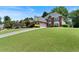 Spacious brick home on a grassy lot with a long driveway to the garage at 3820 Ridge Point Dr, Suwanee, GA 30024