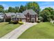 Beautiful brick home with mature trees, well-manicured lawn, and a driveway at 3820 Ridge Point Dr, Suwanee, GA 30024