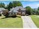 Charming two-story brick home featuring lush landscaping and a long driveway at 3820 Ridge Point Dr, Suwanee, GA 30024