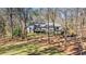 Exterior rear view of home highlighting the large backyard, deck, and additional storage shed at 675 Mayes, Powder Springs, GA 30127