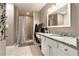 Bathroom featuring a granite countertop vanity and a tiled shower-tub combo with seating area at 675 Mayes, Powder Springs, GA 30127