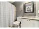 Well-lit bathroom featuring a shower-tub combo, granite countertop vanity, and decorative mirror at 675 Mayes, Powder Springs, GA 30127