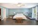 Bright bedroom featuring hardwood floors, a ceiling fan, and natural light from a window at 675 Mayes, Powder Springs, GA 30127