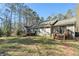 The rear exterior of this well-maintained home showcases a spacious deck and backyard at 675 Mayes, Powder Springs, GA 30127