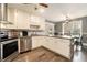 Bright kitchen with white cabinets, granite countertops, stainless appliances, and an adjacent dining area at 675 Mayes, Powder Springs, GA 30127
