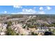 An aerial view shows the rooftops of the neighborhood homes, the street layout and surrounding woods at 949 Tumlin Trce, Lawrenceville, GA 30045