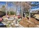 A backyard firepit area with stone pavers and a ring of Adirondack chairs at 949 Tumlin Trce, Lawrenceville, GA 30045