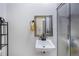 Bathroom featuring a white sink, a gold framed mirror, and a shower with a frosted glass door at 949 Tumlin Trce, Lawrenceville, GA 30045
