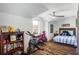 Cozy bedroom featuring luxury vinyl plank flooring, a ceiling fan, and natural light from the window at 949 Tumlin Trce, Lawrenceville, GA 30045