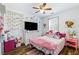 Bedroom featuring a ceiling fan, luxury vinyl plank flooring, natural light and nice wall decor at 949 Tumlin Trce, Lawrenceville, GA 30045