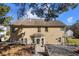 Back exterior view showcasing the deck, patio area, and sloped backyard at 949 Tumlin Trce, Lawrenceville, GA 30045