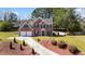 Beautiful two-story brick home with a two car garage, a long driveway, and luscious landscaping at 949 Tumlin Trce, Lawrenceville, GA 30045