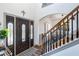 Bright foyer featuring a decorative front door with leaded glass sidelights and an open staircase to the upper level at 949 Tumlin Trce, Lawrenceville, GA 30045