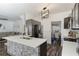 Open concept kitchen with a central island, breakfast bar, and stainless steel appliances overlooking the living area at 949 Tumlin Trce, Lawrenceville, GA 30045