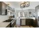 Modern kitchen showcases dark wood cabinets, white countertops, stainless steel appliances and light wood flooring at 949 Tumlin Trce, Lawrenceville, GA 30045