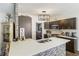 Spacious kitchen featuring a large island with seating, stainless steel appliances and modern lighting fixtures at 949 Tumlin Trce, Lawrenceville, GA 30045
