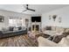 Bright living room with fireplace, ceiling fan, and combined seating at 949 Tumlin Trce, Lawrenceville, GA 30045