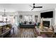 Bright living room with modern ceiling fan, fireplace, and stylish furniture arrangement at 949 Tumlin Trce, Lawrenceville, GA 30045