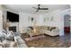Spacious living room featuring a fireplace, ceiling fan, and cozy sectional sofa at 949 Tumlin Trce, Lawrenceville, GA 30045