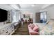 Spacious main bedroom with tray ceiling, sitting area, and luxury vinyl plank flooring throughout at 949 Tumlin Trce, Lawrenceville, GA 30045