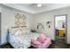 Bright main bedroom with modern furniture, ceiling fan, and adjoining bathroom at 949 Tumlin Trce, Lawrenceville, GA 30045