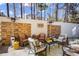 A stone accented outdoor patio features a seating area and gas heaters for year round enjoyment at 949 Tumlin Trce, Lawrenceville, GA 30045
