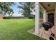 Green backyard with a covered patio perfect for outdoor cooking and relaxation at 1777 Meadow Sw Ln, Atlanta, GA 30315