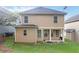 Exterior view of the home with a backyard, patio, and lush lawn at 1777 Meadow Sw Ln, Atlanta, GA 30315