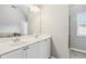 Bright bathroom with double sink vanity, large mirror, and neutral wall color at 1777 Meadow Sw Ln, Atlanta, GA 30315