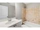 Bathroom featuring a single sink vanity, toilet, and a shower-tub combination with tiled walls at 1777 Meadow Sw Ln, Atlanta, GA 30315