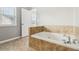 Bathroom with large soaking tub and a window providing natural light at 1777 Meadow Sw Ln, Atlanta, GA 30315