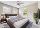 Staged bedroom with large windows, a ceiling fan, a queen bed, and side tables with lamps at 1777 Meadow Sw Ln, Atlanta, GA 30315