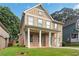 Inviting two-story home with a covered porch, showcasing its well-manicured lawn and classic design at 1777 Meadow Sw Ln, Atlanta, GA 30315