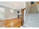 Open-concept living room with fireplace and adjacent staircase at 1777 Meadow Sw Ln, Atlanta, GA 30315