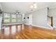 Open-concept living room with hardwood floors, fireplace, staircase, and great natural light at 1777 Meadow Sw Ln, Atlanta, GA 30315