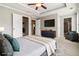 Staged main bedroom with carpet, ceiling fan, television, and en suite bathroom at 1777 Meadow Sw Ln, Atlanta, GA 30315