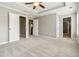 Main bedroom with carpet floors, tray ceiling, television, and en suite bathroom at 1777 Meadow Sw Ln, Atlanta, GA 30315