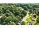 Aerial view of a neighborhood featuring abundant trees, quiet streets, and well-kept homes in a suburban environment at 2995 Ivy Mill Dr, Buford, GA 30519