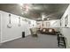 Spacious basement featuring gray carpet, with instruments and a leather sofa, great for a home music room at 2995 Ivy Mill Dr, Buford, GA 30519