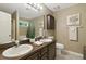 Bathroom with double sink vanity, linen closet, shower, garden tub, and decorative touches at 2995 Ivy Mill Dr, Buford, GA 30519