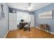 Bedroom area with blue walls, hardwood floors, storage cabinets, a work space and natural lighting at 2995 Ivy Mill Dr, Buford, GA 30519