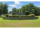 A landscaped entrance to Briarglen Ivy Creek features a stone wall and manicured shrubbery underneath the community sign at 2995 Ivy Mill Dr, Buford, GA 30519