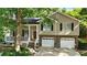 Traditional two-story home features a two-car garage and covered porch with brick and siding at 2995 Ivy Mill Dr, Buford, GA 30519