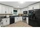 Modern kitchen with white cabinets, granite countertops, and stainless steel appliances at 2995 Ivy Mill Dr, Buford, GA 30519