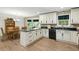 Well-lit eat-in kitchen features white cabinetry and black appliances at 2995 Ivy Mill Dr, Buford, GA 30519